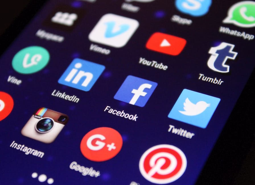 Close-up of a smartphone screen showing various social media app icons such as Facebook and Twitter. - pitääkö whatsapp päivittää?